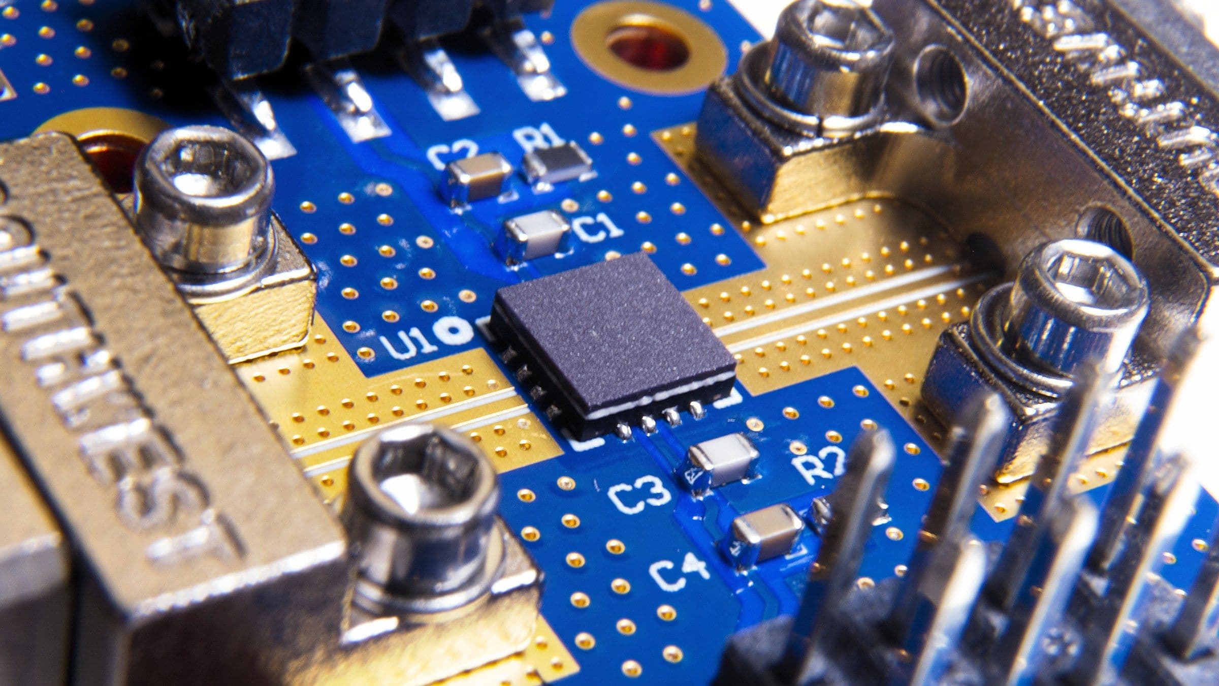 Falcomm Dual-Drive QFN package seated on an evaluation board, photographed up close